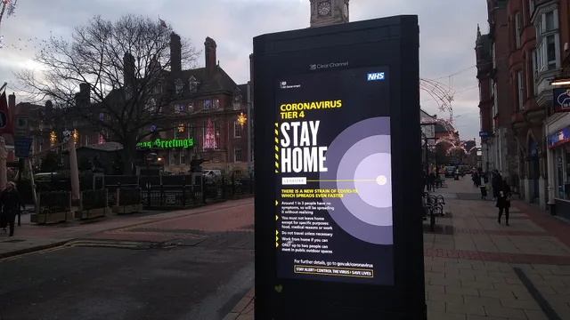 Digital billboard displaying a warning for Tier 4 restrictions in Leicester. This is on Horsefair street, near the Town Hall, which can also be seen in the picture with the Christmas lights still up. What does a digital billboard cost in the UK?