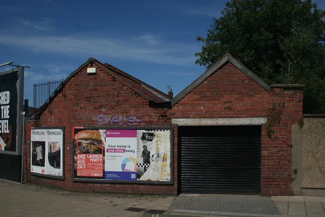 A picture of a garage and billboards on Felix Road in Bristol, England. Cross-border OOH from Belfast and Derry to Republic of Ireland audiences