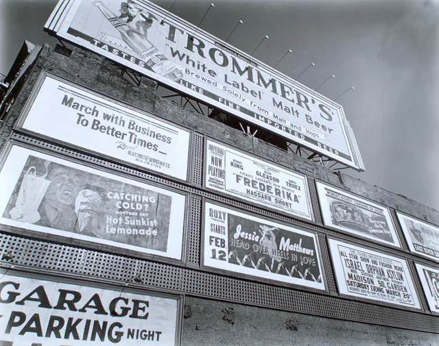 * Wall lined with billboards, large one at top, ads for shows, medicine, beer, a magazine, 'There's no way like the American way...,' etc. Citation/Reference: CNY# 205 Code: III.I. What an out of home advertising disclosure policy means for UK buyers