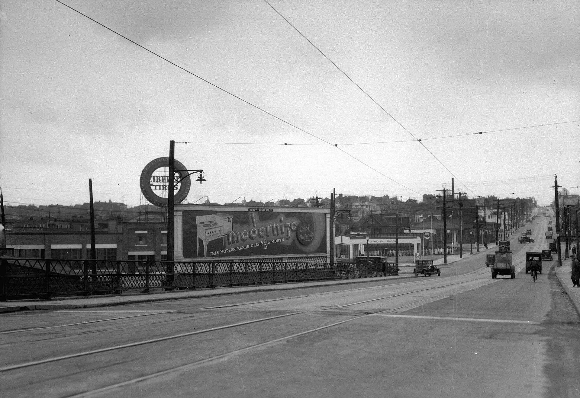 Vancouver . Lighted Ruddy-Duker Ltd. billboard advertising Modernize Electric Ranges.